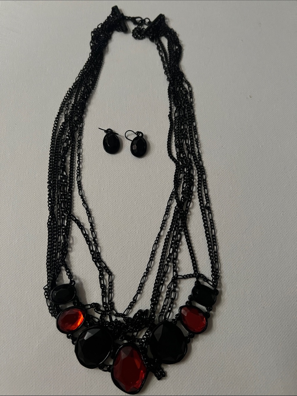 Multi-Strand Black Chain Necklace with Red Gem Accents